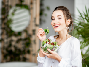 A variety of colorful, nutrient-rich foods including fruits, vegetables, and fermented foods displayed on a wooden table to illustrate the connection between diet, gut health, and mental well-being.